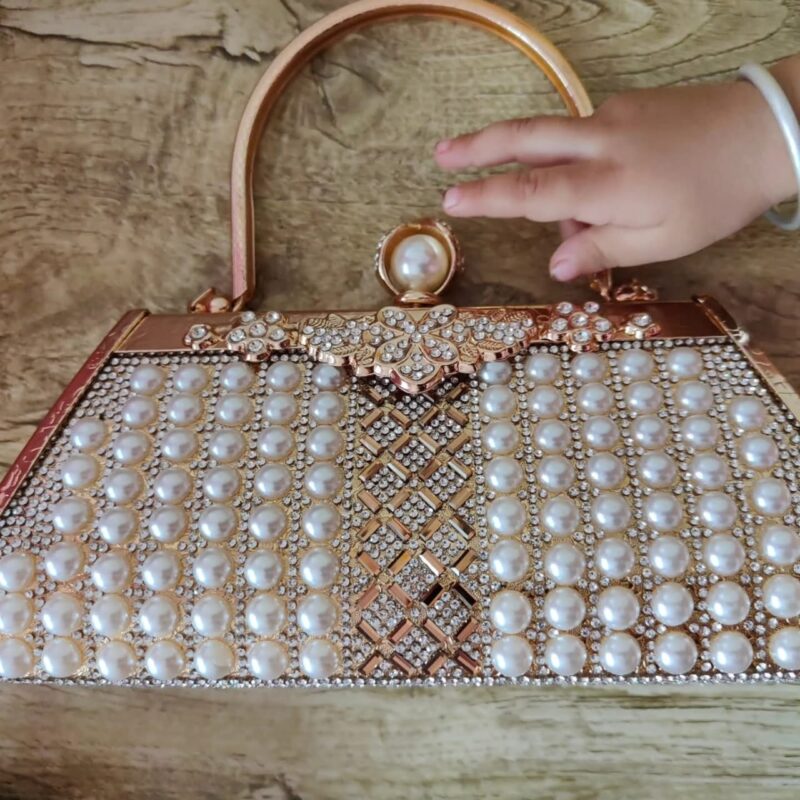 Clutch purse including pearls and rhinestones