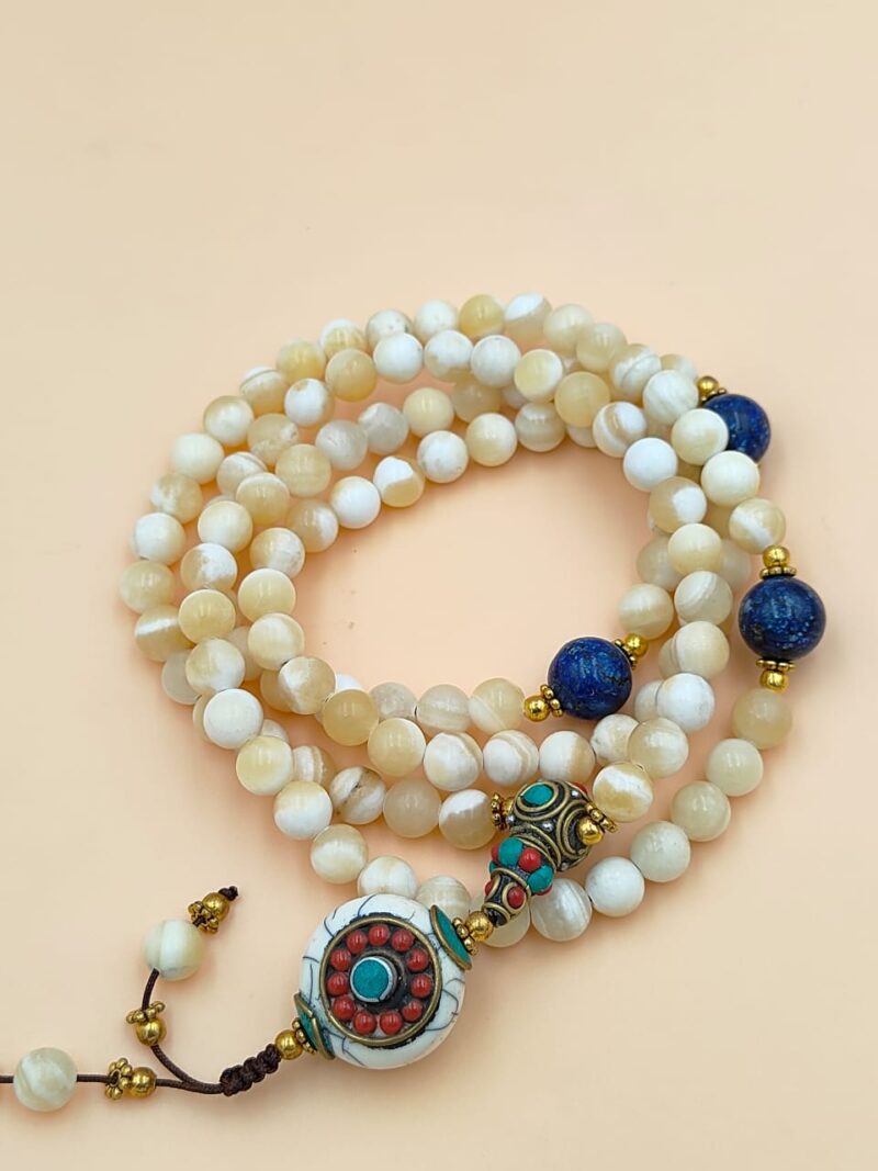 Designed mother of pearl beads mala including lapis lazuli.