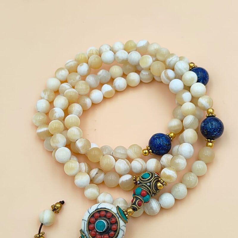 Designed mother of pearl beads mala including lapis lazuli.